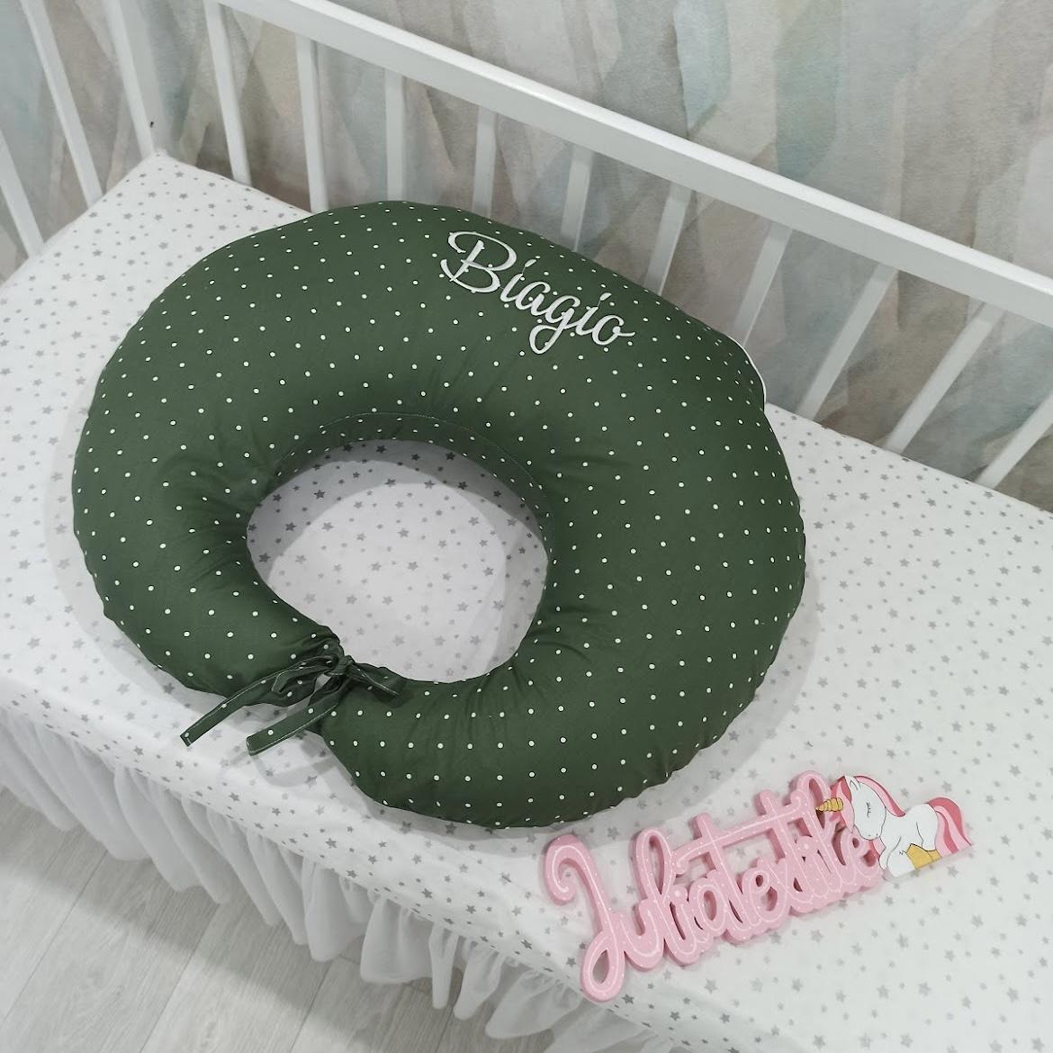 Green nursing pillow with white polka dots