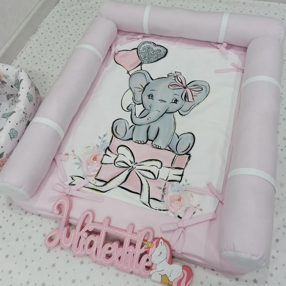 Changing table with pink and white elephant print